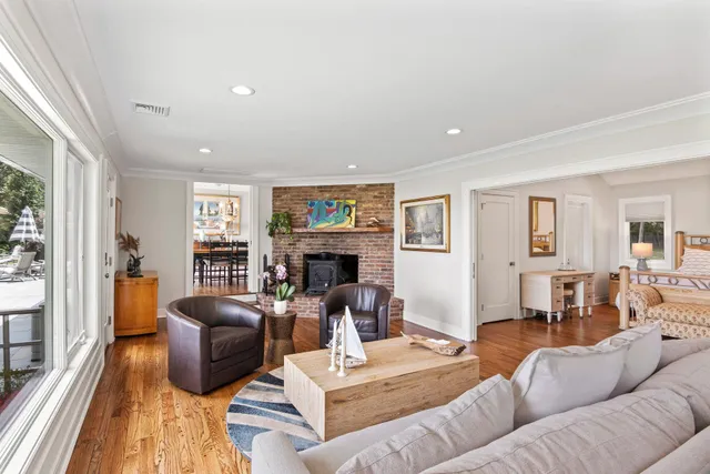 a living room with furniture fireplace and a large window