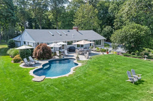 a aerial view of a house with swimming pool and patio