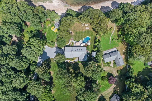 an aerial view of a houses with a yard