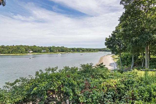 a view of a swimming pool with a patio and a yard