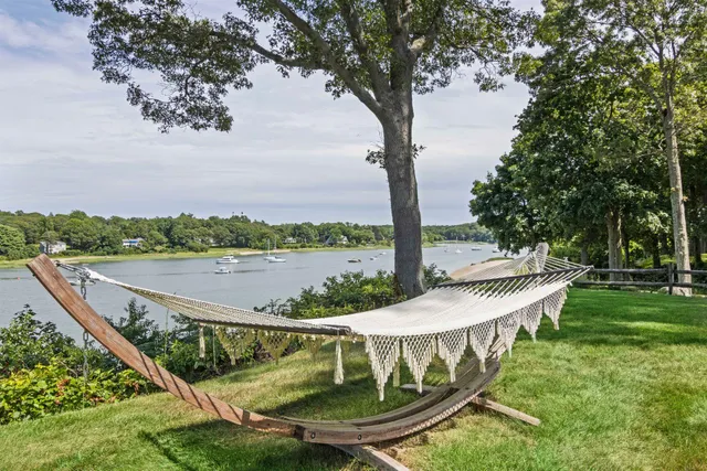 a front view of a house with a yard table and chairs