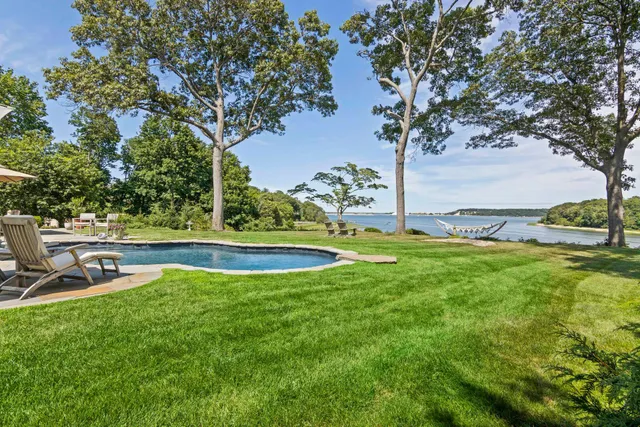 an aerial view of a house with a yard basket ball court and outdoor seating