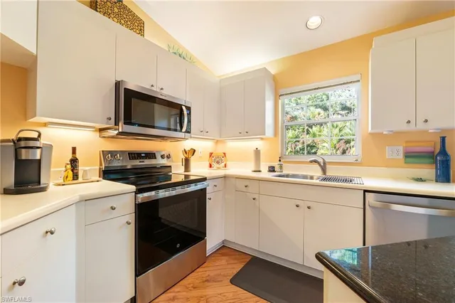 a kitchen with a sink stove and microwave