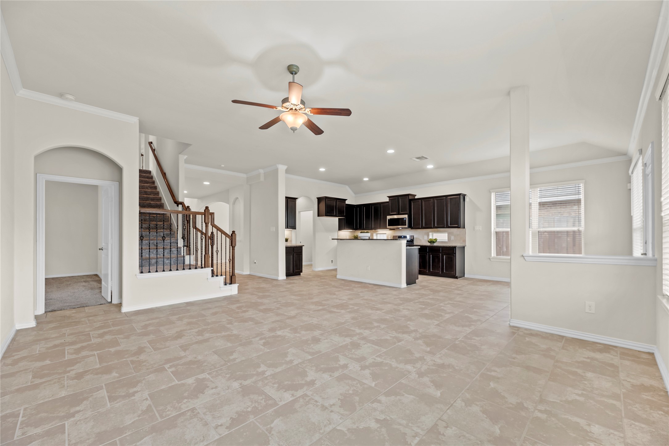 5205 Rainy Garden Court Rosharon, TX 77583 - Photo 13 of 40 Truly open concept, the family room has clear sights to both the dining area and kitchen. Whether entertaining guests or keeping an eye on the littles, this layout delivers for modern needs and desires.
