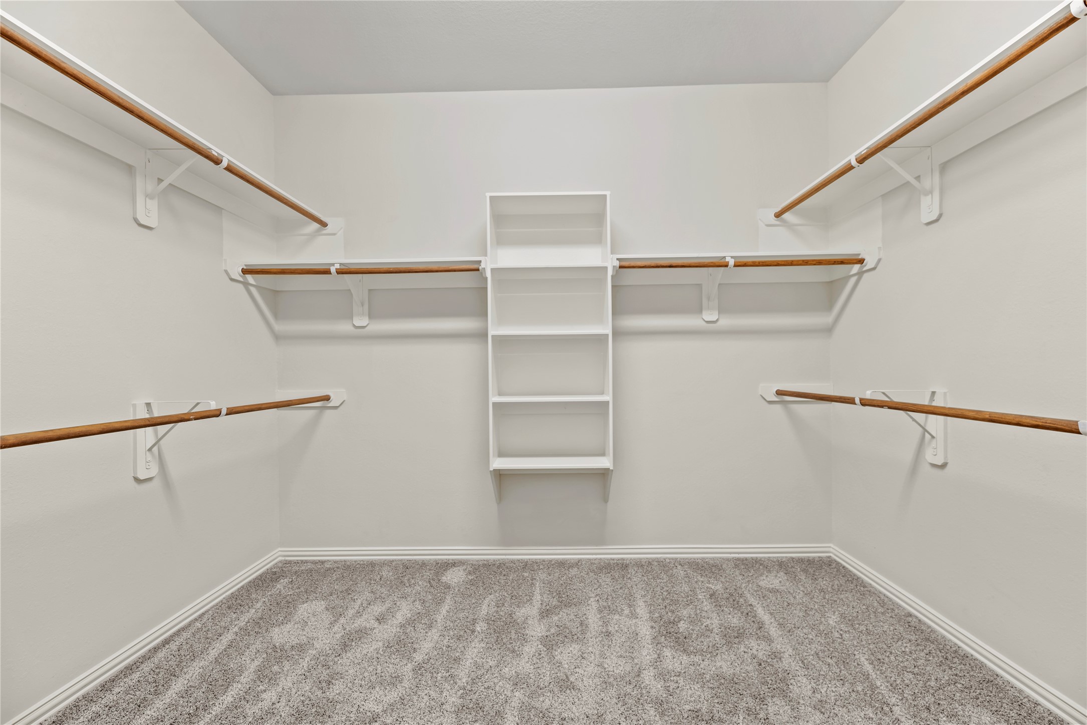 5205 Rainy Garden Court Rosharon, TX 77583 - Photo 19 of 40 No matter how often you purchase new threads online or at the mall, this walk-in primary bedroom closet has space for all your new and favorite wares!