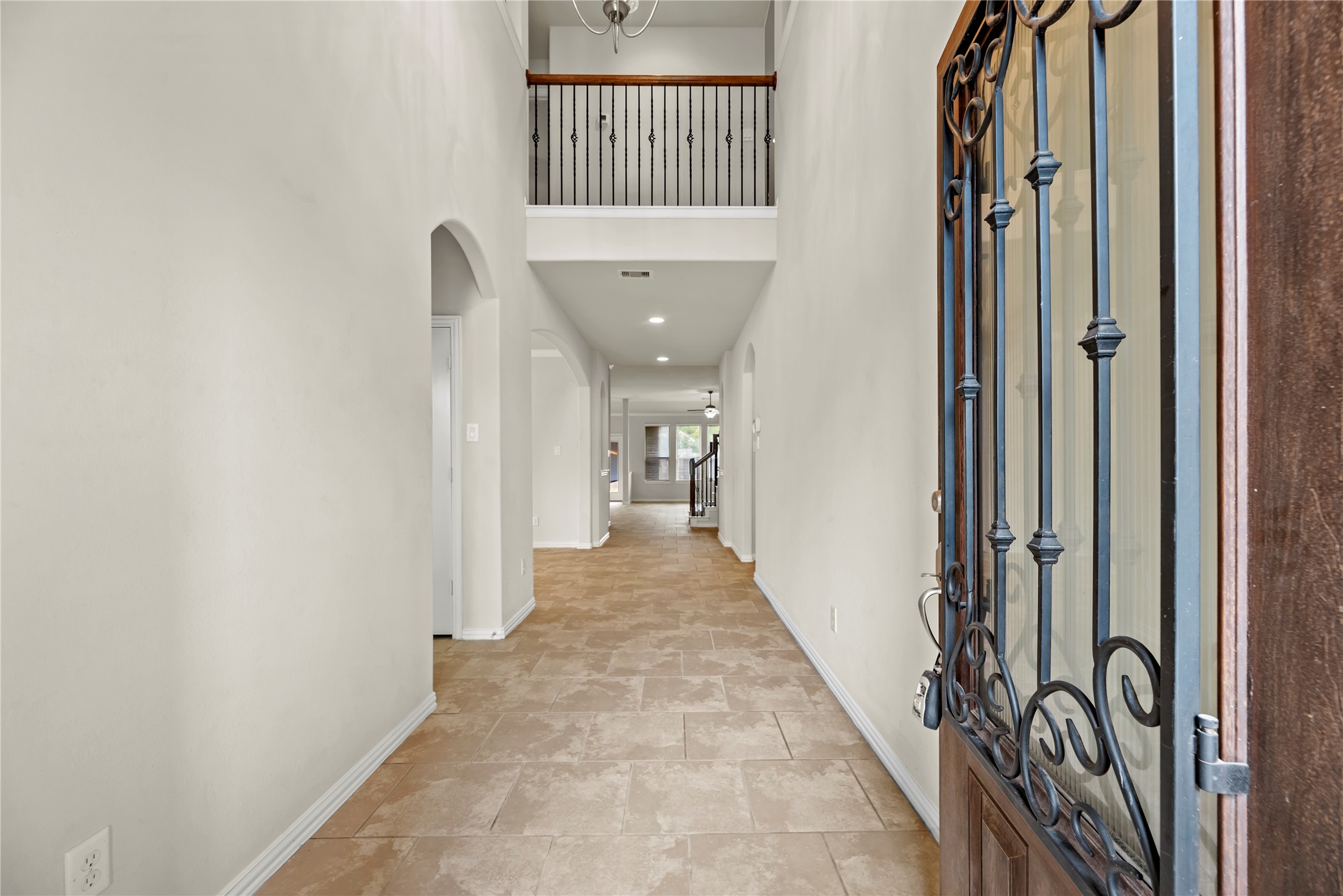 5205 Rainy Garden Court Rosharon, TX 77583 - Photo 2 of 40 a view of a hallway with wooden floor and staircase