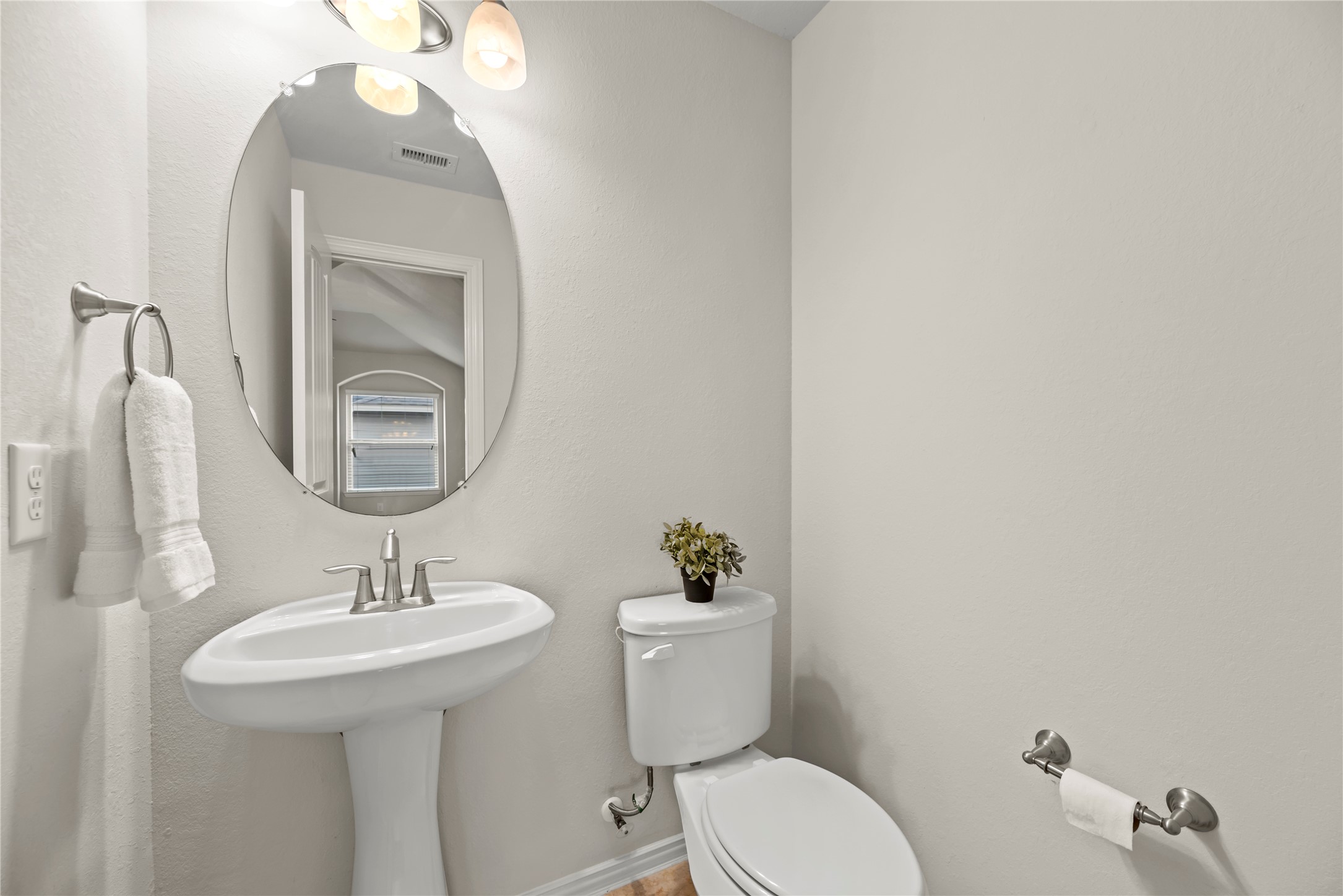 5205 Rainy Garden Court Rosharon, TX 77583 - Photo 30 of 40 a bathroom with a toilet sink and mirror