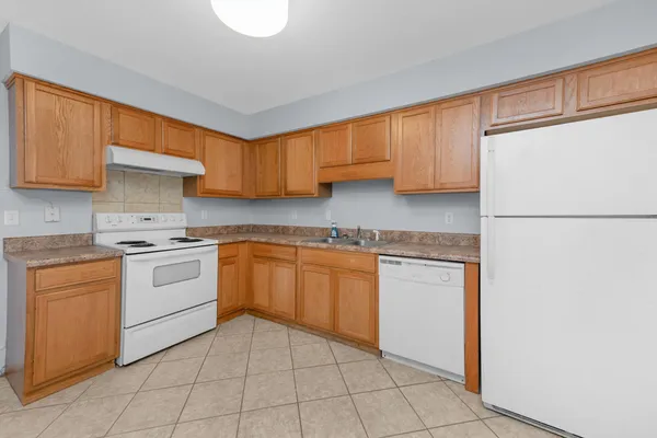 a kitchen with a stove top oven sink and cabinets