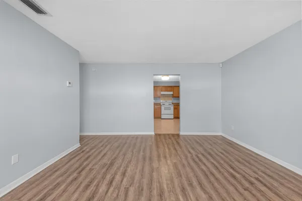 a view of a room with wooden floor and brick walls