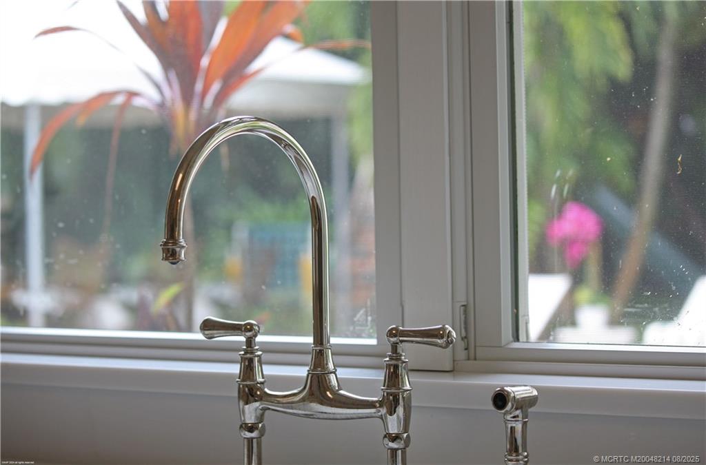16 Ridgeview Road North Sewall's Point, FL 34996 - Photo 23 of 88 a bathroom with a granite countertop sink and mirror