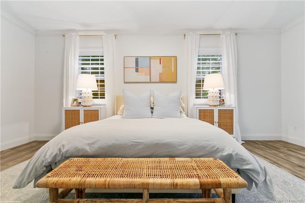 16 Ridgeview Road North Sewall's Point, FL 34996 - Photo 57 of 88 a bedroom with a bed and wooden floor