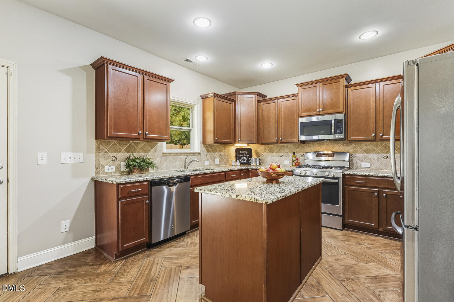 1008 Poplar Street Durham, NC 27703 - Photo 16 of 73 a kitchen with stainless steel appliances granite countertop a sink stove refrigerator and cabinets