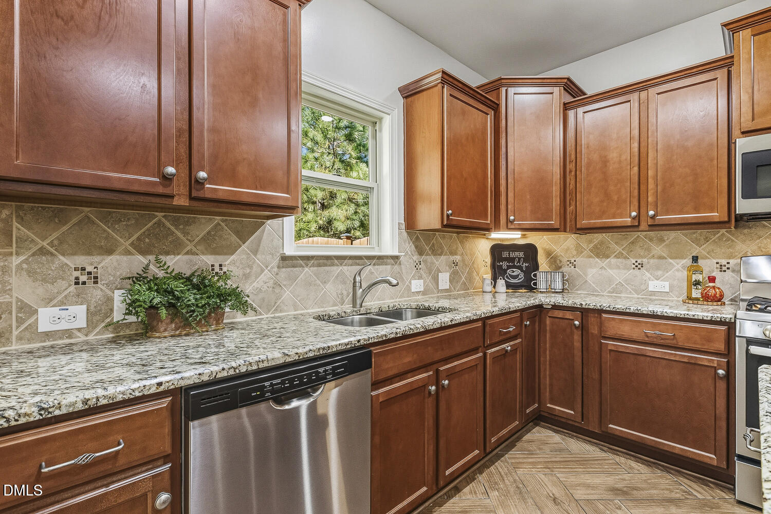 1008 Poplar Street Durham, NC 27703 - Photo 19 of 73 a kitchen with stainless steel appliances granite countertop a sink a stove and a wooden cabinets