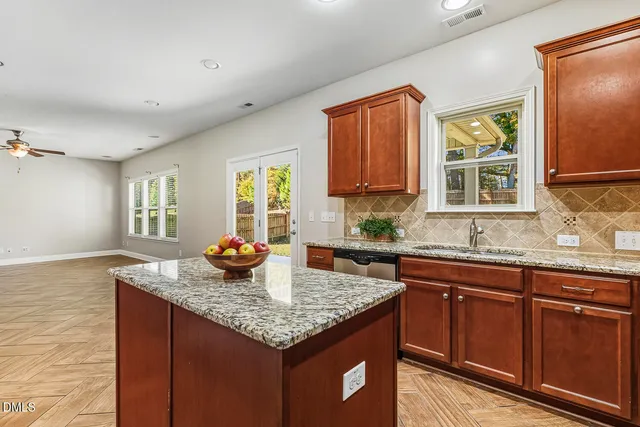 a kitchen with granite countertop wood cabinets and stainless steel appliances