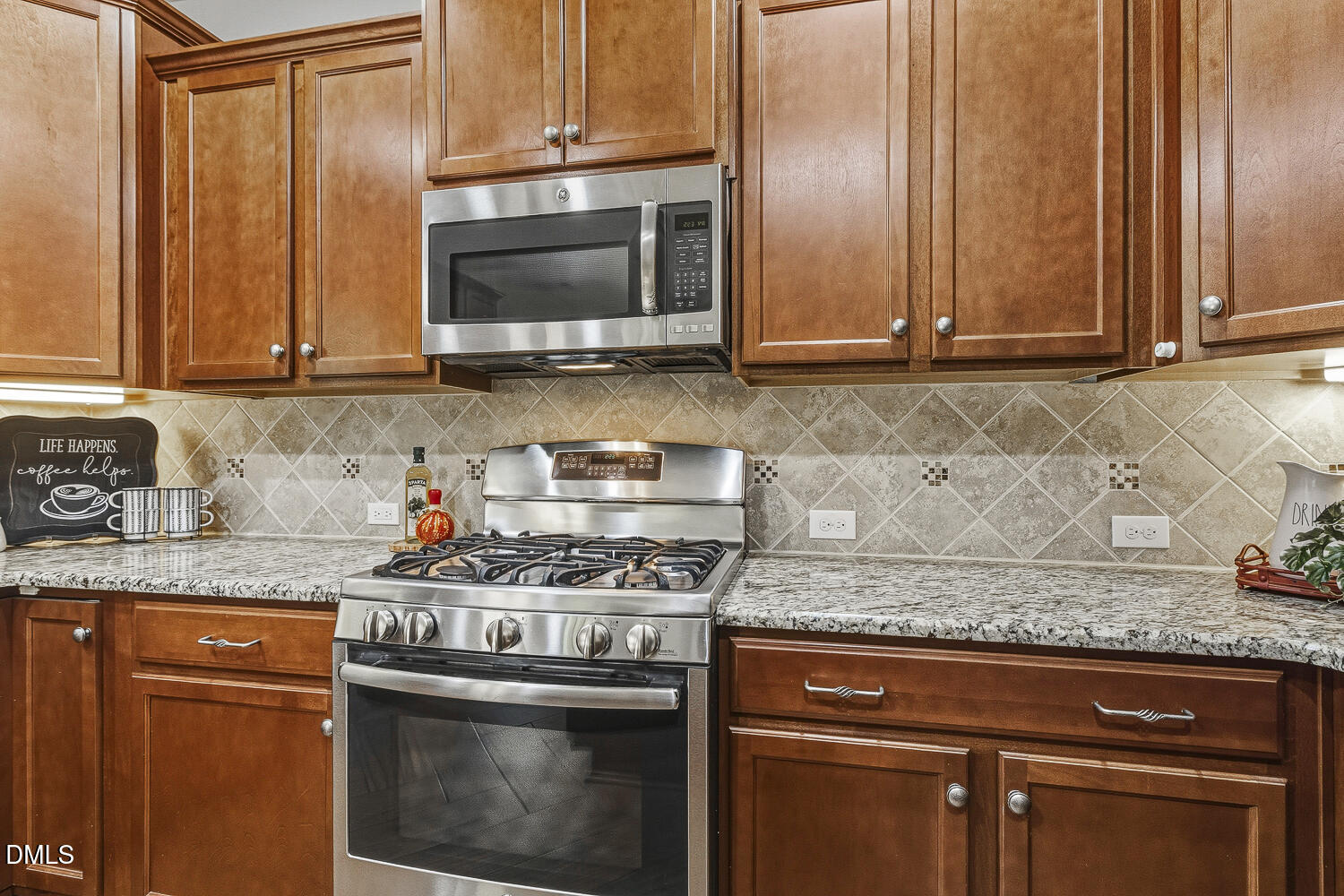 1008 Poplar Street Durham, NC 27703 - Photo 25 of 73 a kitchen with granite countertop wood cabinets and stainless steel appliances