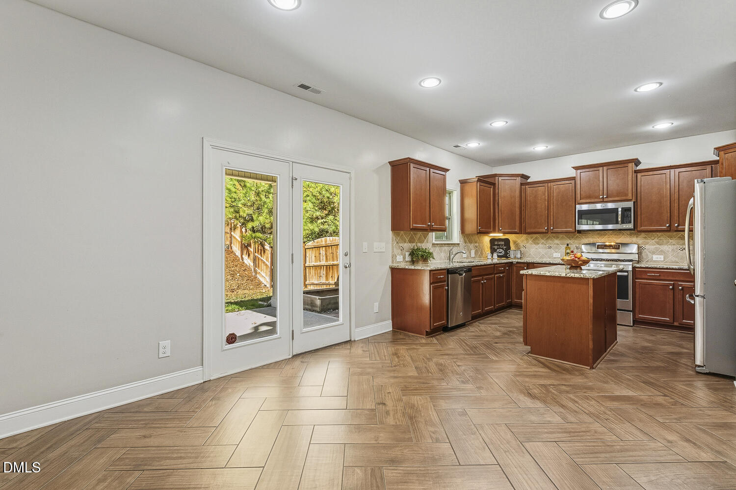 1008 Poplar Street Durham, NC 27703 - Photo 27 of 73 a large kitchen with stainless steel appliances granite countertop a stove top oven a sink dishwasher and white cabinets