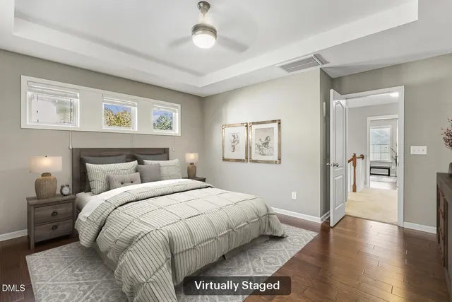 a view of an empty room with a window and a kitchen