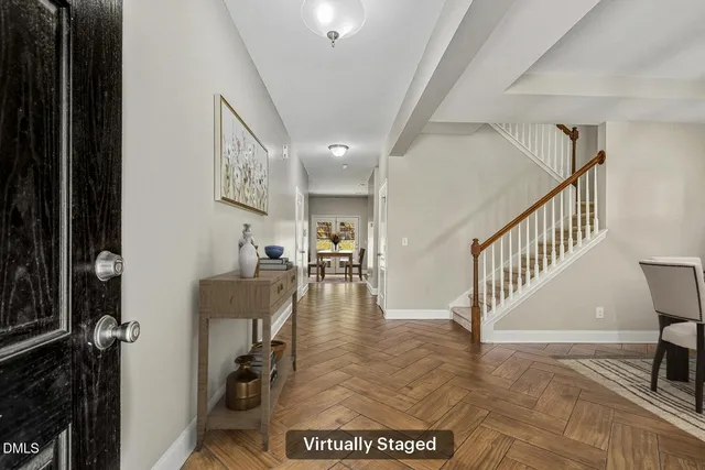 a dining room with furniture a chandelier and wooden floor