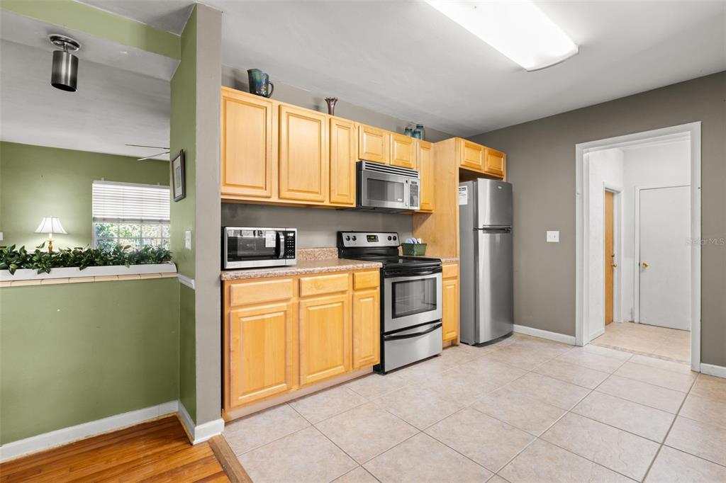 909 Woodley Road Clearwater, FL 33764 - Photo 11 of 29 a kitchen with granite countertop a refrigerator and a stove top oven