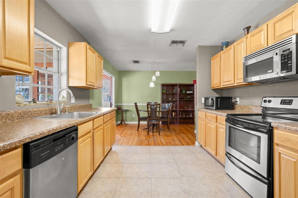 909 Woodley Road Clearwater, FL 33764 - Photo 12 of 29 a kitchen with stainless steel appliances granite countertop a stove and a sink