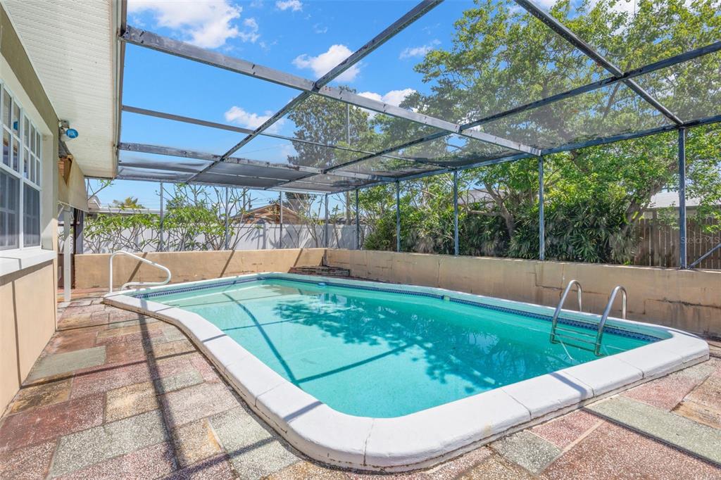 909 Woodley Road Clearwater, FL 33764 - Photo 17 of 29 a view of a swimming pool with a patio