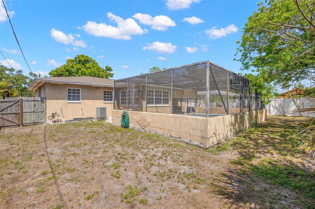 909 Woodley Road Clearwater, FL 33764 - Photo 18 of 29 a view of a house with a wooden fence