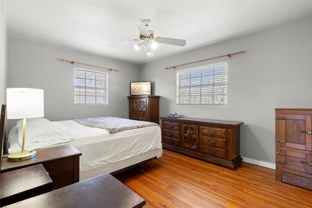909 Woodley Road Clearwater, FL 33764 - Photo 21 of 29 a bedroom with a large bed and a chandelier
