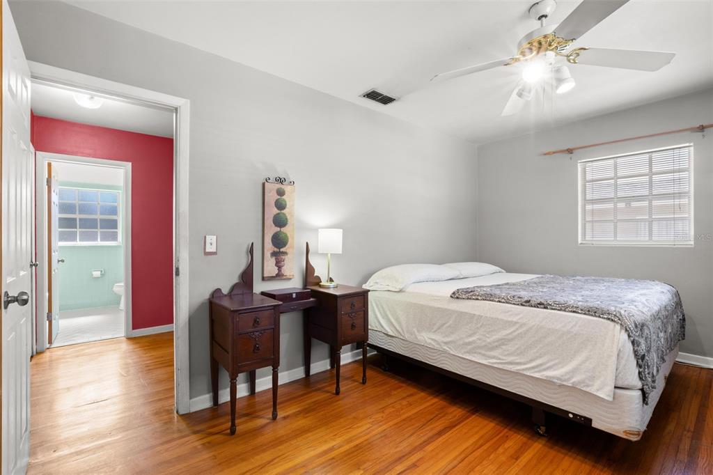 909 Woodley Road Clearwater, FL 33764 - Photo 22 of 29 a bedroom with a bed and a table