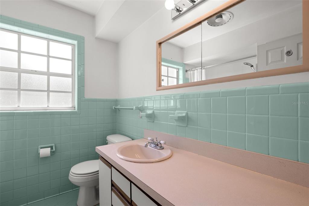 909 Woodley Road Clearwater, FL 33764 - Photo 25 of 29 a bathroom with a sink and a toilet