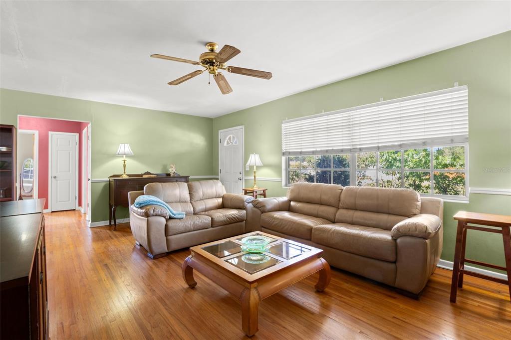 909 Woodley Road Clearwater, FL 33764 - Photo 6 of 29 a living room with furniture and a large window