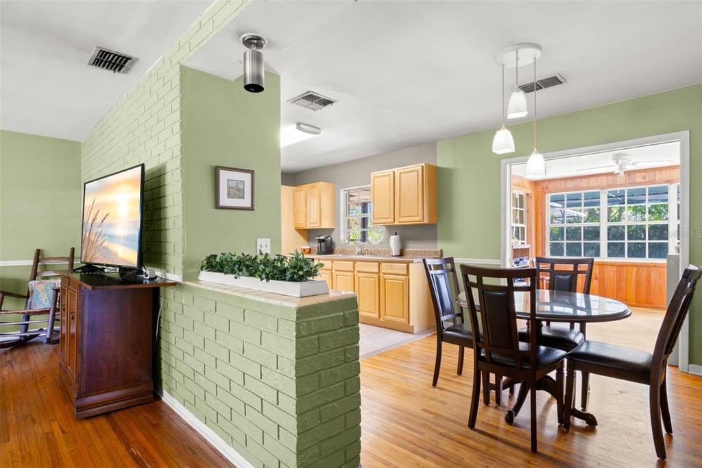 909 Woodley Road Clearwater, FL 33764 - Photo 8 of 29 a dining room with furniture and wooden floor