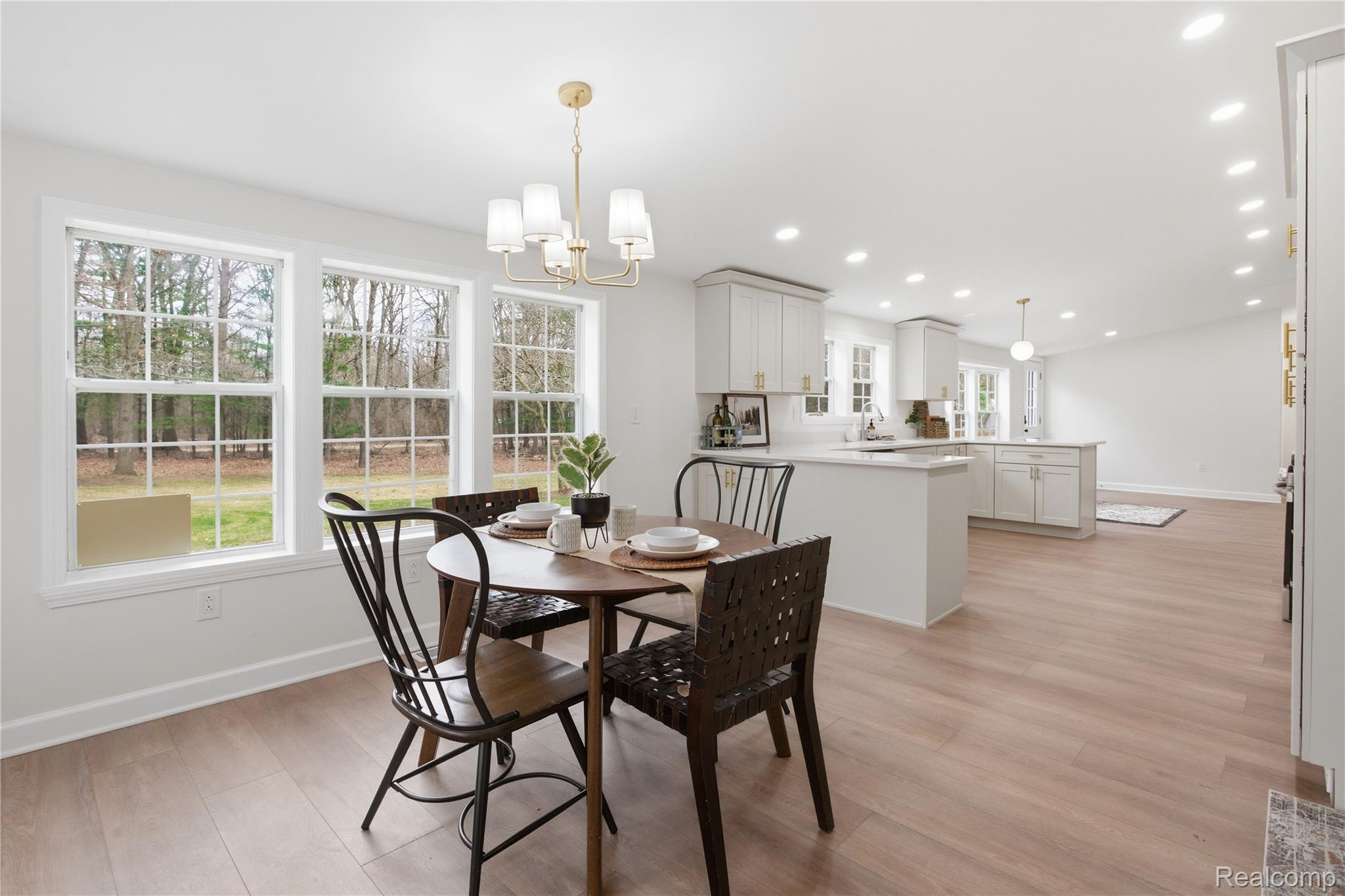 5350 List Road Grass Lake, MI 49240 - Photo 21 of 71 Dining space featuring a chandelier and light wood finished floors
