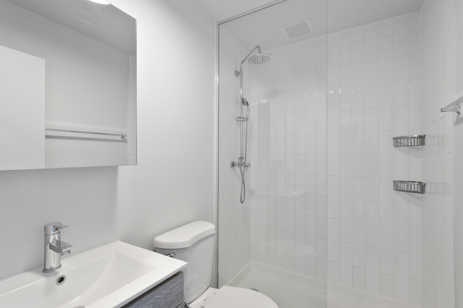 1325 West Wilson Avenue, Unit 907 Chicago, IL 60640 - Photo 8 of 19 a bathroom with a sink toilet and shower