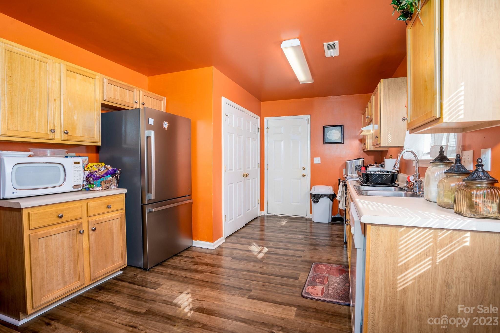 907 McDonald Road Charlotte, NC 28214 - Photo 11 of 28 a kitchen with stainless steel appliances granite countertop a refrigerator a stove and a sink with cabinets