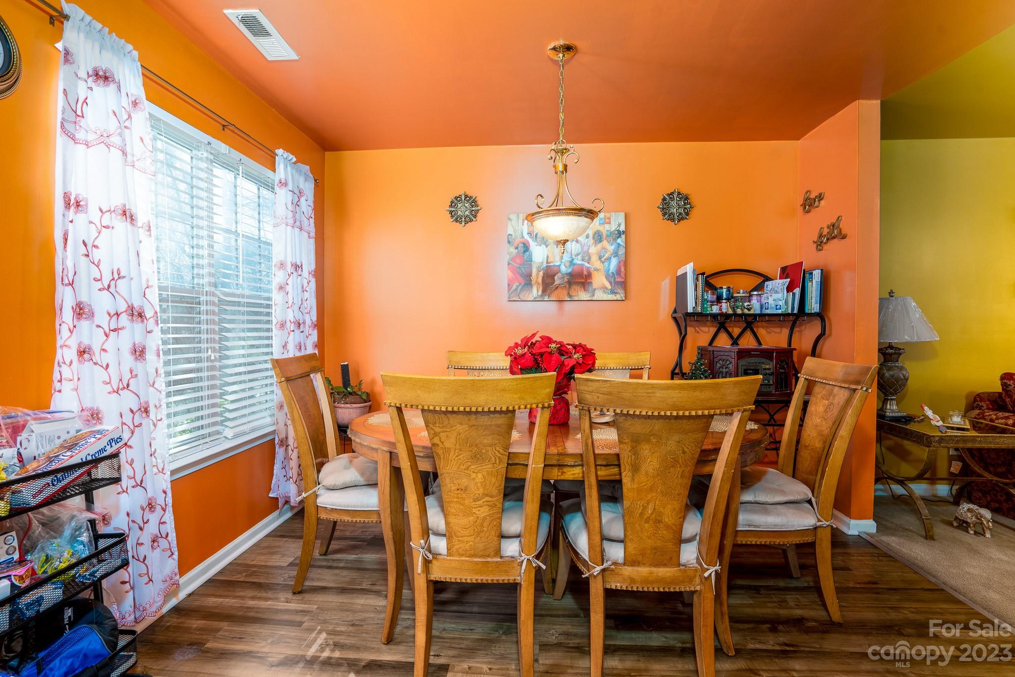 907 McDonald Road Charlotte, NC 28214 - Photo 15 of 28 a view of a dining room with furniture and wooden floor