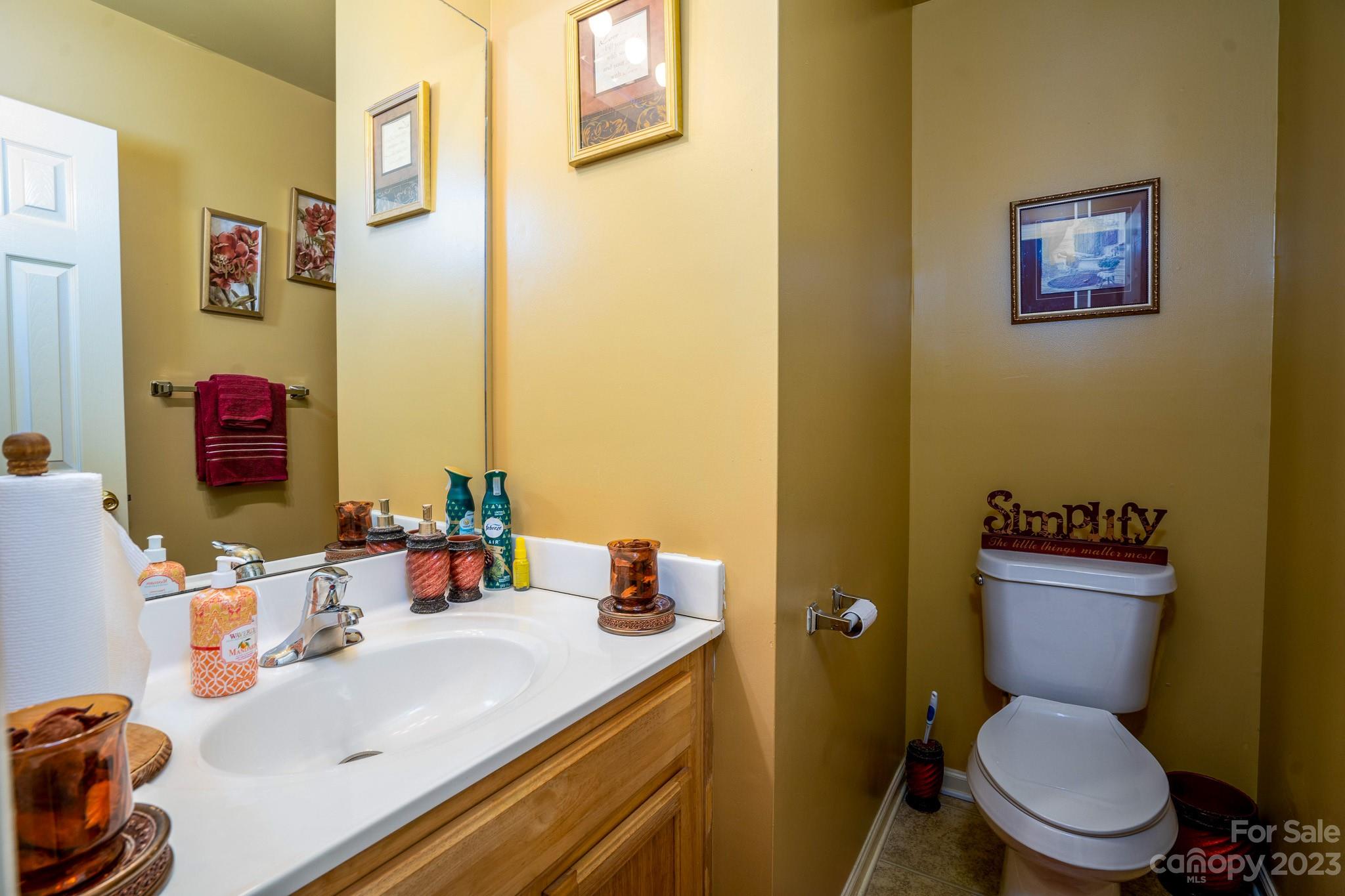 907 McDonald Road Charlotte, NC 28214 - Photo 10 of 28 a bathroom with a sink a toilet and a mirror