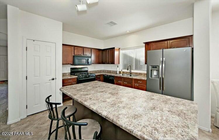 650 North Robles Street Dewey, AZ 86327 - Photo 5 of 13 a kitchen with stainless steel appliances granite countertop a refrigerator sink and microwave