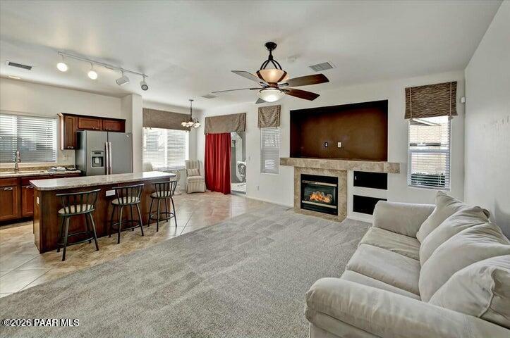 650 North Robles Street Dewey, AZ 86327 - Photo 8 of 13 a living room with furniture a flat screen tv and a fireplace