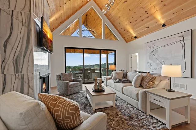 a bathroom with a granite countertop sink a toilet a mirror and shower
