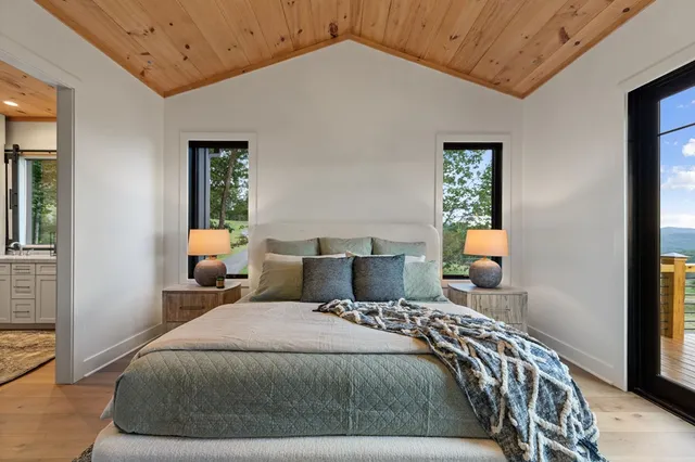 a view of a kitchen with a sink and a large window