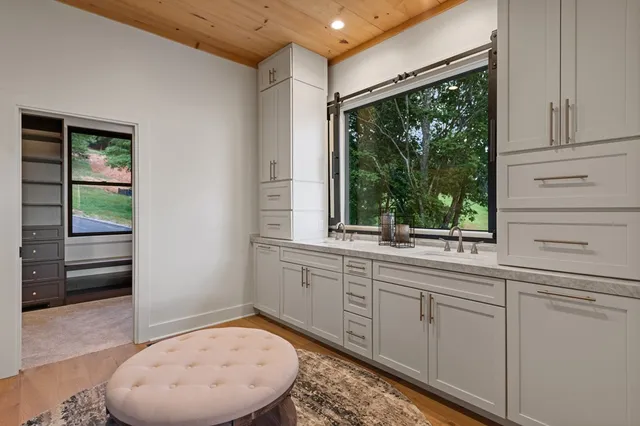 a sink with a mirror and window