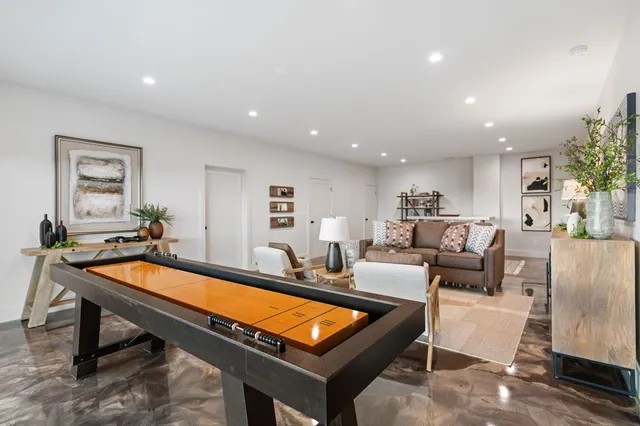 a living room with furniture a rug and a window