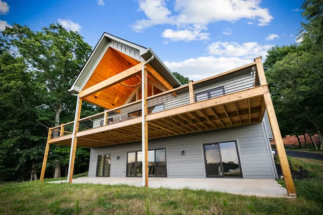 a view of a balcony with wooden floor and lake view