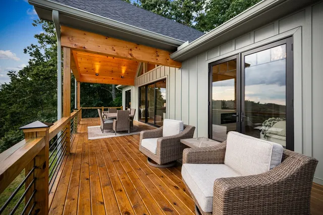 a view of a roof deck with couches and sky view