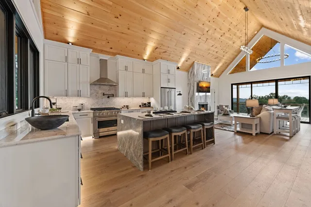 a dining room with furniture a fireplace and wooden floor