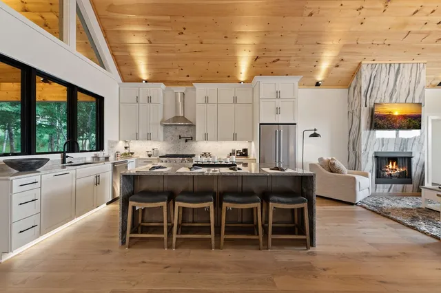 a kitchen with a stove and wooden floor