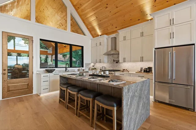 a living room with furniture a fireplace and a chandelier