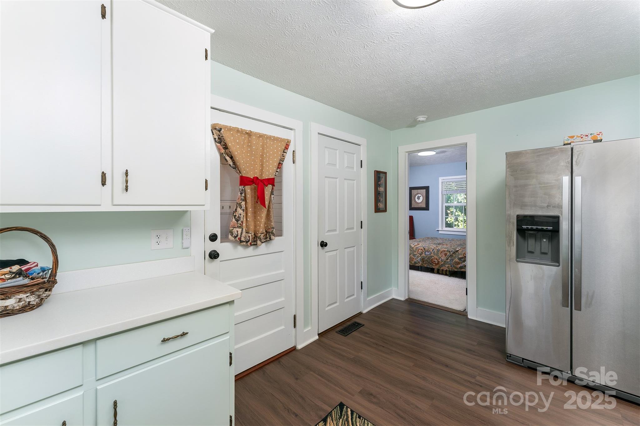 1434 Lake Adger Road Mill Spring, NC 28756 - Photo 12 of 48 a kitchen with a refrigerator and cabinets