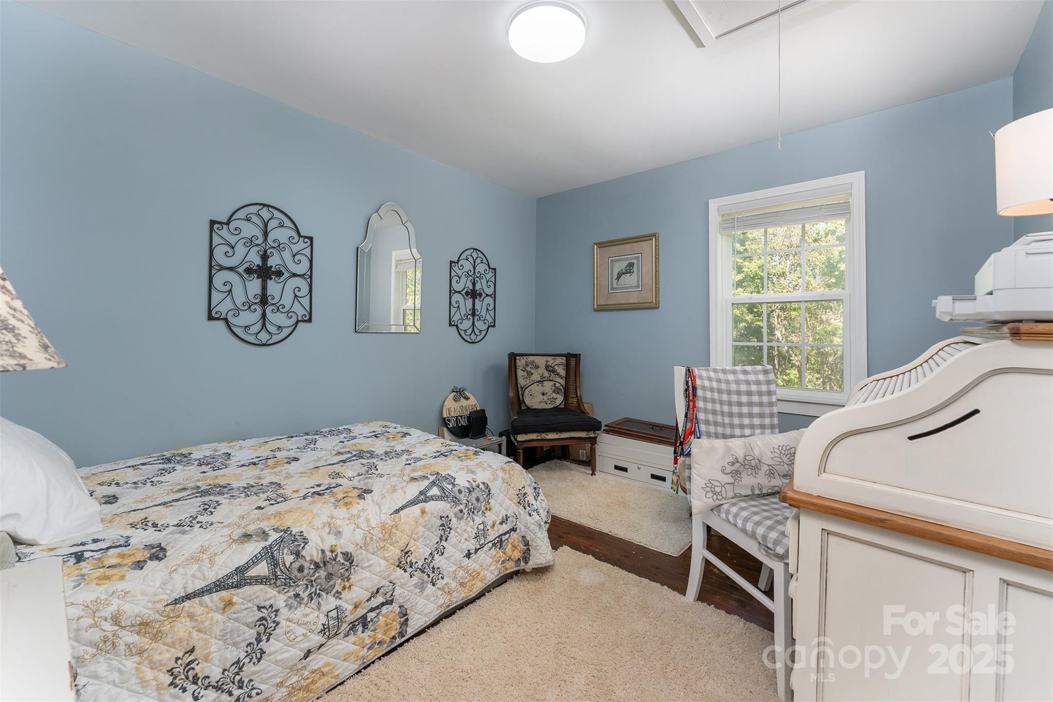 1434 Lake Adger Road Mill Spring, NC 28756 - Photo 14 of 48 a bedroom with a bed and wooden floor