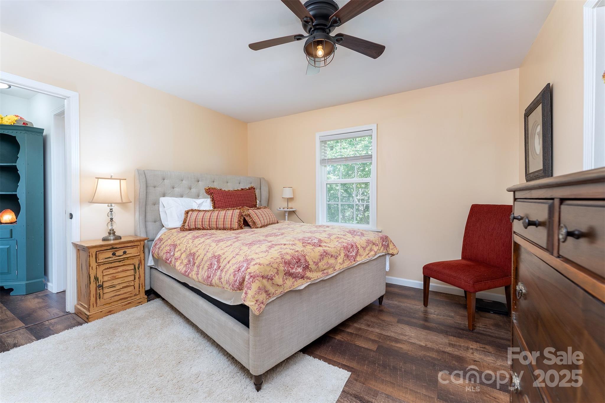 1434 Lake Adger Road Mill Spring, NC 28756 - Photo 16 of 48 a bedroom with a bed chair and window